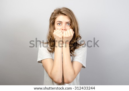 scared woman looking in camera Royalty-Free Stock Photo #312433244