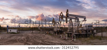 Oil and gas industry. Panoramic of a pump jack and oil refinery.