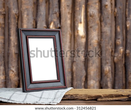 Picture frame put on wood background.