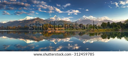 Incredible Himalayas. Panoramic view from the lakeside at the foothills of the magnificent Annapurna mountain range.  Royalty-Free Stock Photo #312459785