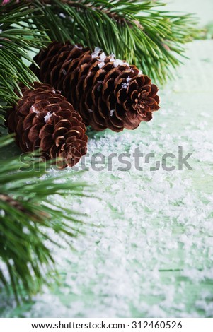 christmas background. fir branches and cones on snow-covered wooden background. selective focus. copy space for you text