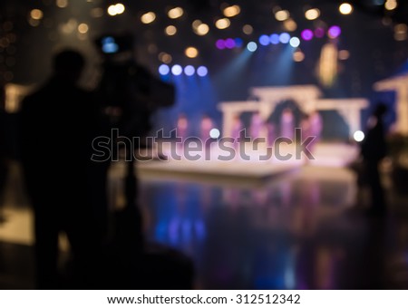 Actress or singer in studio of television station with camera