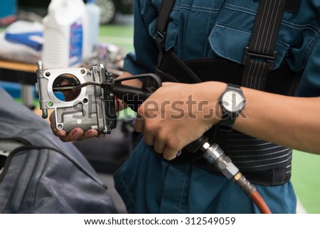 Repair the carburetor with its valves of the combustion engine Royalty-Free Stock Photo #312549059