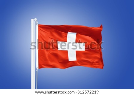 Flag of Switzerland flying against a blue sky.
