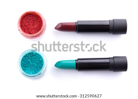 Edgy color lipsticks with matching eye shadows, top view isolated on white background 