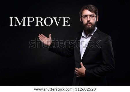 Businessman over black background presenting "Improve"