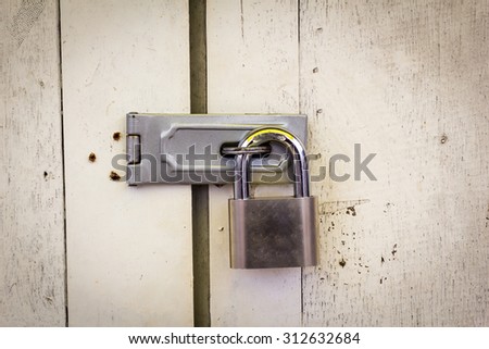 Locked padlock with at door.select focus Royalty-Free Stock Photo #312632684