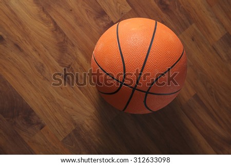 Basketball ball over wooden floor