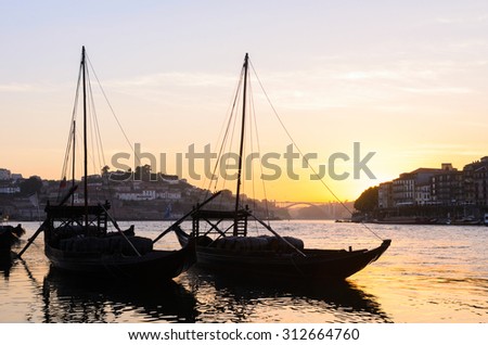 sunset view of traditional boats and Douro river in Porto, Portugal