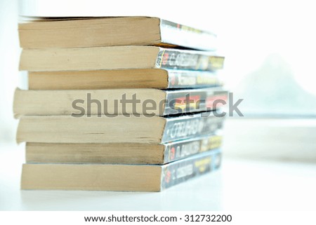 Books on white windowsill, close up