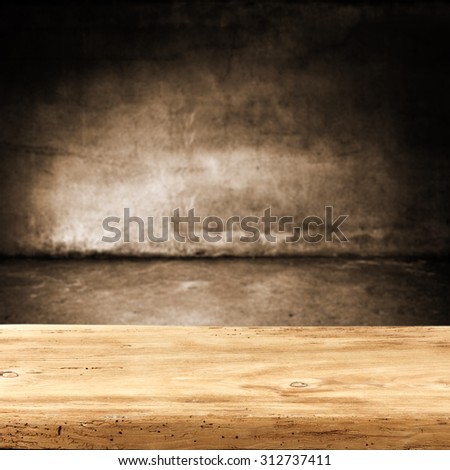 dark blurred wall of brown color and dark shadows with desk of free space 