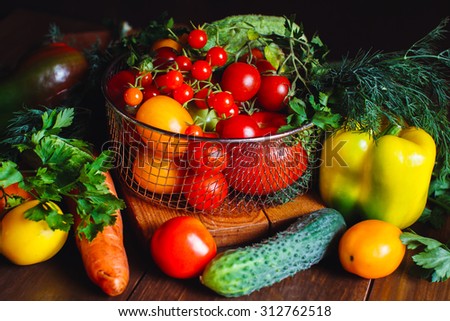 View of a delicious assortment of farm fresh vegetables and herbs  spread out on a rustic wooden table