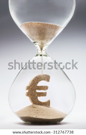 Time is money concept with falling sand taking the shape of a euro