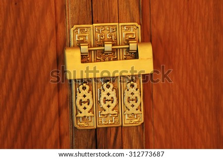 copper lock on wooden furniture, closeup of photo