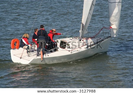 Sailing teacher with three students on a sailingboat at sea Royalty-Free Stock Photo #3127988