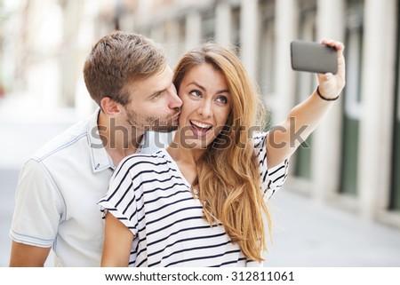 Portrait of a happy couple making selfie photo with smartphone