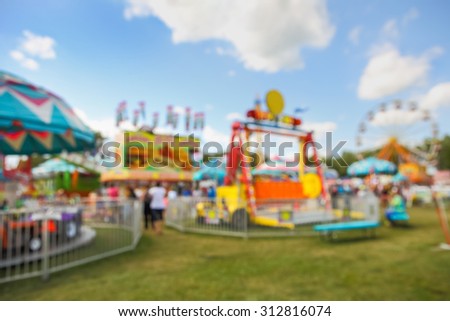 Blurred background of a carnival midway.