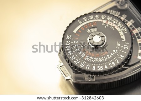 Close-up of dial of vintage mechanical photography light meter.