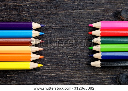 Colored pencils on wooden table for presentation
