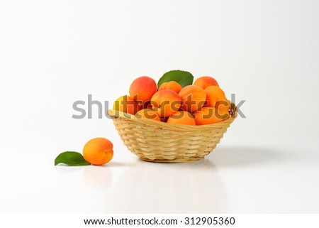 straw basket full of matured apricots