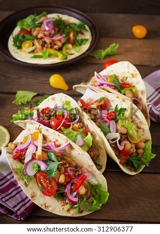 Mexican tacos with meat, beans and salsa