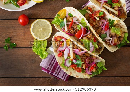 Mexican tacos with meat, beans and salsa. Top view
