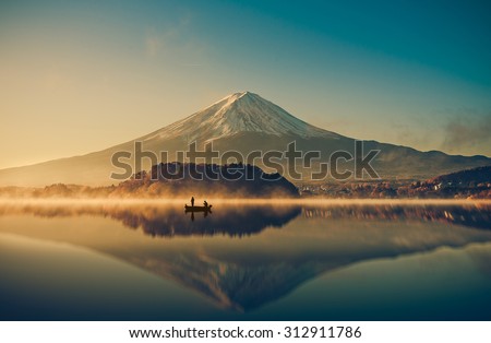 Mount fuji san at Lake kawaguchiko in japan on sunrise.  vintage tone  Royalty-Free Stock Photo #312911786
