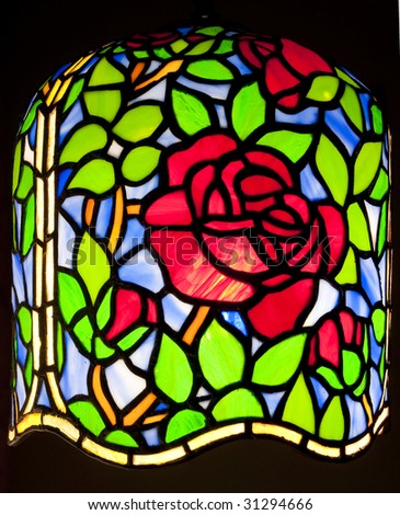 a tiffany lamp with rose pattern isolated on black