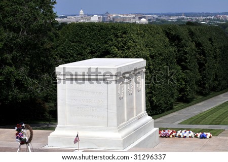 Tomb of the Unknown Soldier at the Arlington National Cemetery in Arlington, Virginia, with the skyline of Washington DC visible in the background