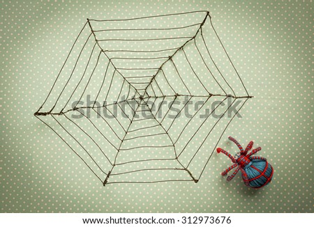 Vintage style background of Wire spider web and blue thread spider