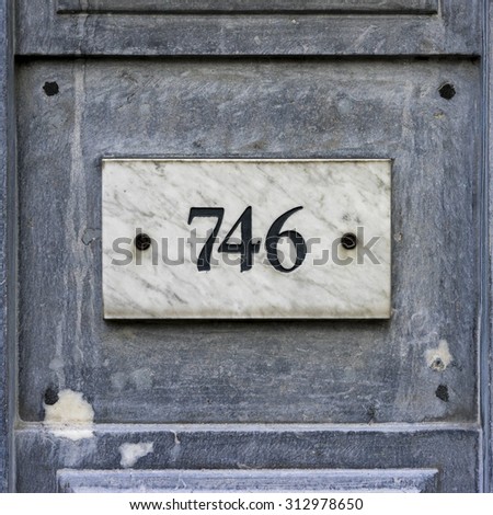 house number seven hundred and forty six, engraved in a marble plate