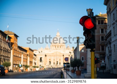 Photo of Saint Peter's Basilica and square in Vatican with red light in the foreground