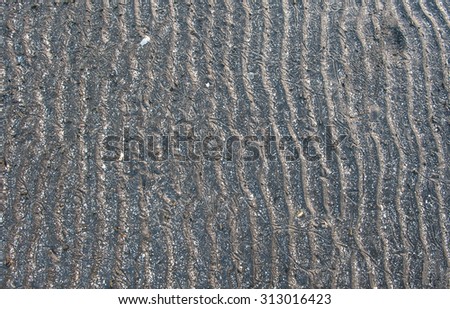 Blurred lines wavy surface sediment naturally black. 