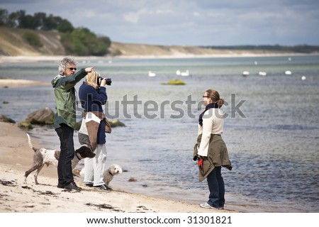 Photographer, model and director at a shoot on the beach