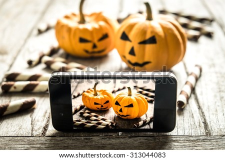 Halloween pumpkin with take picture in mobile phone