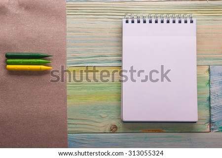 Top view of blank note book, calendar with colorful pencils. Back to school, copy space. Education background. Artistic, artist, art.
