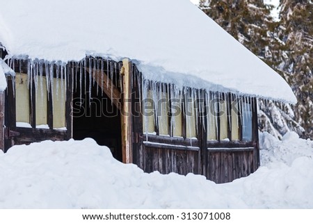 Photo of icicles hanging on old house