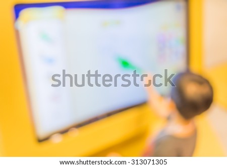 blur image of kids touching on big touch screen  computer.