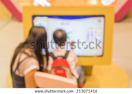 blur image of kids touching on big touch screen  computer.