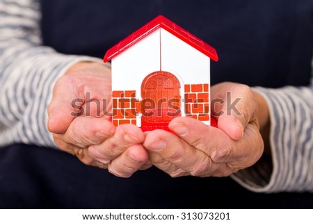 Close up photo of miniature house holding in hands