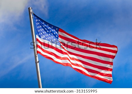 American flag waving against the blue sky