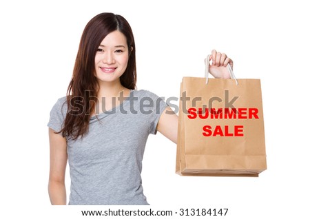 Asian Woman hold with shopping bag for showing phrase of summer sale