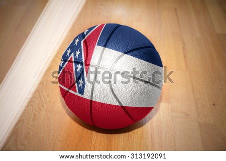 basketball ball with the flag of mississippi state lying on the floor near the white line
