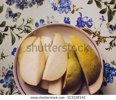 Sliced pears on floral patterned table cloth
