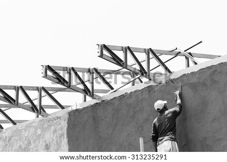 Black and white rural worker working at construction site on daytime