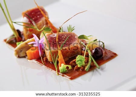 Yellow fin tuna with fresh vegetables and soya sauce Royalty-Free Stock Photo #313235525