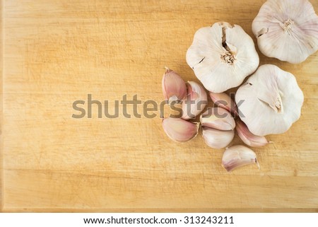 Overhead view of garlic on wood background