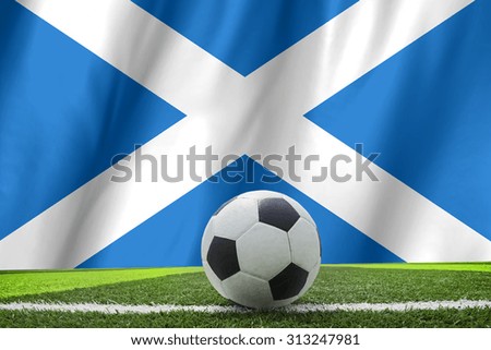 Flag of scotland with football in front of it
