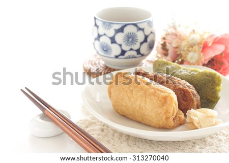 Japanese food, inarizushi and Japanese tea Royalty-Free Stock Photo #313270040