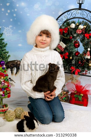 beautiful girl in a white cap and knit sweater on the background of Christmas decorations